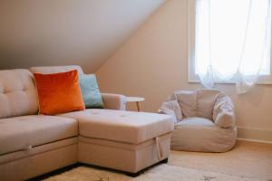 a living room with a couch and a chair at The Cambridge House in Milwaukee