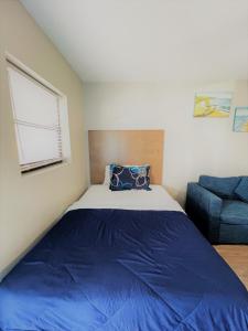 a bedroom with a large bed and a couch at Sand Dollar Motel in Atlantic Beach