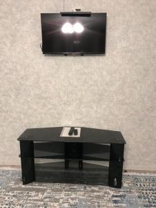 a black coffee table in front of a tv at Аэропорт Алматы in (( Turksib ))