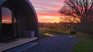 a view of a sunset from the outside of a house at Odli Glamping - Luxury Glamping Pod in Welshpool