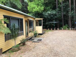 a house with a yard in front of it at Sweetwater Cottage. A private mountain escape in Upper Burringbar