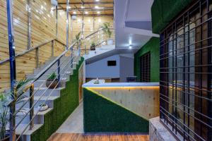 an office with a green wall and stairs at Itsy By Treebo - Shri Gv Inn 600 Mtrs From Tiffin Top in Nainital