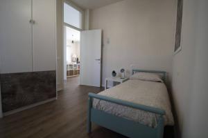 a bedroom with a bed and a door to a room at Casa Ol Gàl in Bergamo