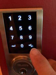 a persons hand is pushing a button on a clock at Adirondack Valley House - Close to Saratoga Track in Saratoga Springs