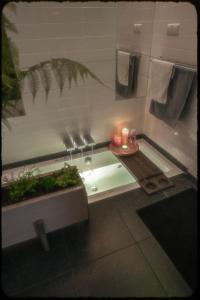a bathroom with a table with candles on it at Lovely, 1898 Jugendstil Design Apartment, old Haarlem city Centre, Fully Renovated with Parkview near Amsterdam and Zandvoort, Bloemendaal Beach in Haarlem