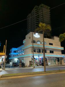 a building on the side of a street at night at Creta Hotel & Suites in Mazatlán