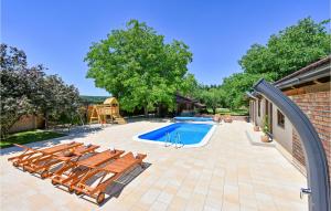 a patio with chairs and a swimming pool at Amazing Home In Bjelovar With Sauna in Bjelovar