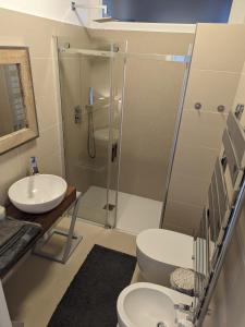 a bathroom with a shower and a toilet and a sink at EXCELSIOR 10 - Luxury apartment in Grado