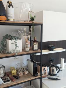a shelf filled with lots of items on it at EXCELSIOR 10 - Luxury apartment in Grado