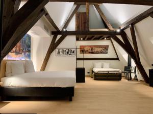 a bedroom with two beds in a attic at Comic Art Hotel in Ghent