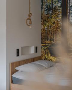 a bedroom with a bed with a painting on the wall at MGM HOME Wawer Międzylesie Centrum Zdrowia Dziecka in Warsaw