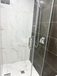 a bathroom with a shower with a glass door at Trafalgar Place in Auckland