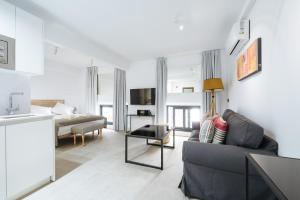 a living room with a couch and a table at apartamentos montevideo 6 in Seville