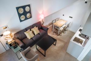 a living room with a couch and a table at apartamentos montevideo 6 in Seville