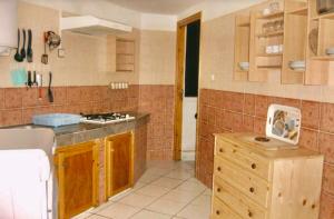 a kitchen with wooden cabinets and a counter top at Jamilasapartment in Agadir