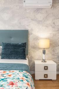 a bedroom with a bed and a lamp on a night stand at Studio Sweet Dreams in Aveiro touristic center in Aveiro
