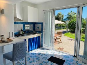 A kitchen or kitchenette at Grazioso MONOLOCALE nella villa NOLELU