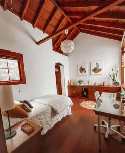 a bedroom with a bed and a desk in a room at Casa La Encarnación in Santa Cruz de la Palma
