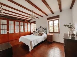 a large bedroom with a bed and a wooden floor at Casa La Encarnación in Santa Cruz de la Palma