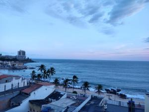 a view of a beach with palm trees and the ocean at Porto Marina in Salvador