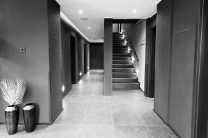 a hallway with a staircase in a building with a vase at Sellmann´s Boutique Hotel in Dortmund