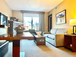a living room with a couch and a table at Mountain View 1 BR Condo With Gym & Hot-Tubs in Canmore