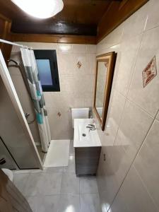 a bathroom with a sink and a mirror at Abrigo da Serra- Nature Trails in Santana