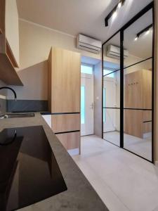 a kitchen with a counter and a large glass door at Apartman Noa in Široki Brijeg