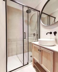 a bathroom with a shower and a sink and a mirror at Apartman Noa in Široki Brijeg
