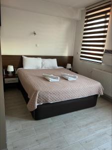 a bedroom with a bed with two trays on it at Deni Apartments in Prilep