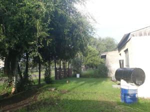a yard with a water tank on the side of a house at WENDY Ranch in Falda del Carmen