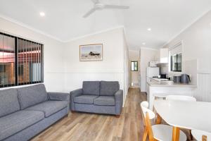 a living room with a couch and a table at Pyramid Holiday Park in Tweed Heads