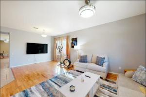 a living room with a couch and a tv at NEW! Stunning Peaceful Peoria Home - Very Close to Sports Complex in Peoria