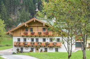 a large white building with a balcony at Bauernhof Krahlehenhof in Filzmoos