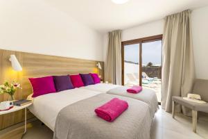A bed or beds in a room at Villa Muzu by Villa Plus Még 10 kép