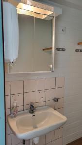 a white sink in a bathroom with a mirror at Ingala in Inkoo