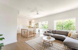 a living room with a couch and a table at Clearwater Noosa Resort in Noosaville