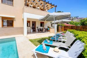 a villa with a swimming pool and a house at Villa Irines House by Villa Plus in Khromonastírion