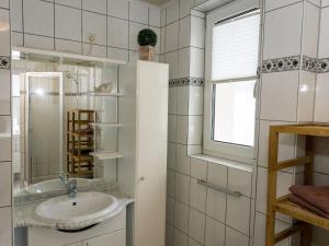 a bathroom with a sink and a mirror at Ferienwohnung im Sauerland in Erndtebrück +32 photos