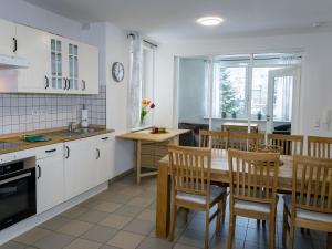 a kitchen and dining room with a table and chairs at Ferienwohnung im Sauerland in Erndtebrück
