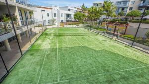 a tennis court with two tennis rackets on it at Swell Resort Burleigh Heads in Gold Coast