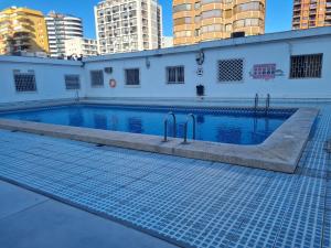 a swimming pool in the middle of a building at Hany apartment Ducado 11-C in Benidorm
