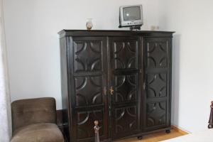 a wooden cabinet with a television on top of it at Hospedaria Boavista in Porto