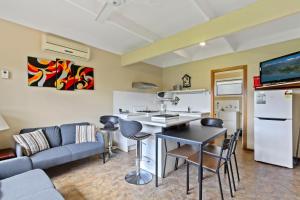 a kitchen and living room with a couch and a table at Ocean Bridge Lakes Entrance in Lakes Entrance