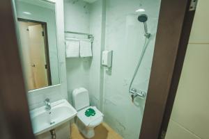 a bathroom with a sink and a toilet and a shower at Hotel 81 Fuji in Singapore