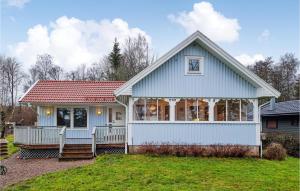 a white house with a red roof at Amazing Home In Hkerum With Sauna, 3 Bedrooms And Wifi in Hökerum