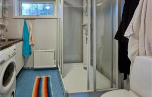 a small bathroom with a shower and a toilet at Amazing Home In Hkerum With Sauna, 3 Bedrooms And Wifi in Hökerum