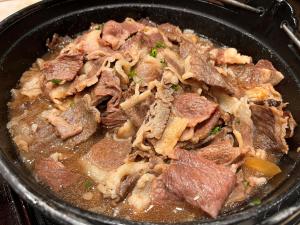 a bowl of food with meat and onions at Onyado Nono Matsumoto Natural Hot Spring in Matsumoto