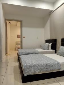 a room with three beds in a room at BS City Homestay1 - Miri Times Square in Miri