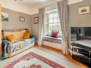 a living room with a couch and a window at Maclaren House in Milford Haven